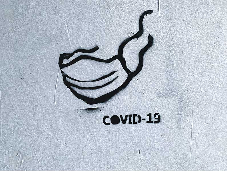 Artist representation of Covid-19 mask on a wall